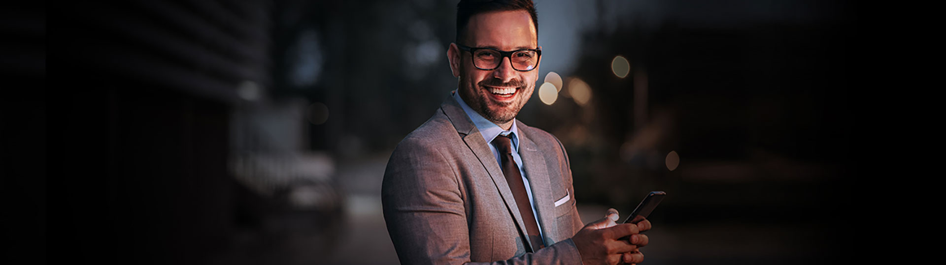 Man smiling using a cell phone