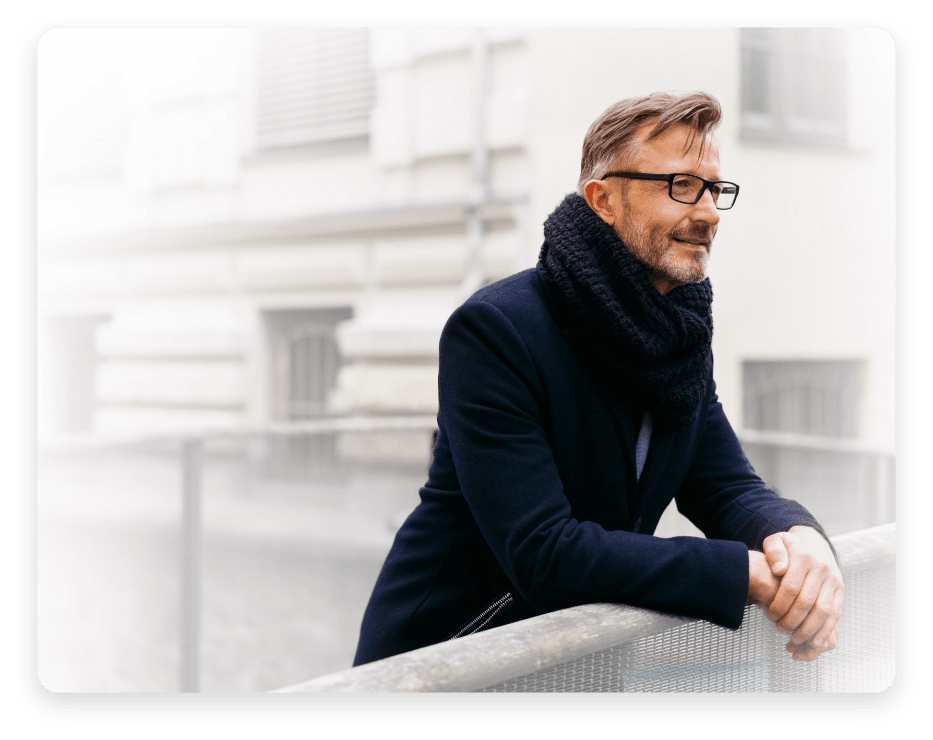 Man leaning against fence